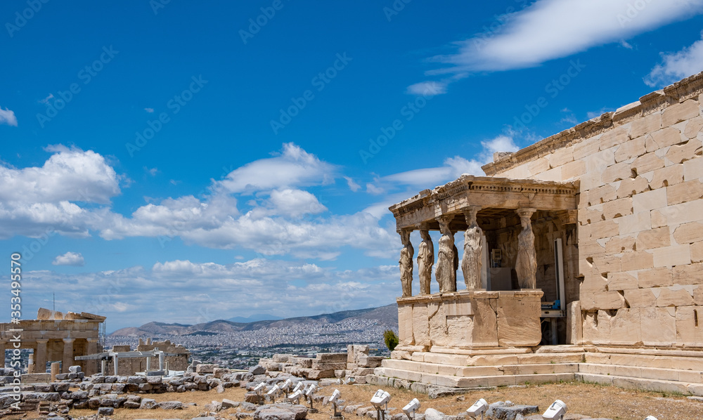 Athens, Greece. Erechtheion with Cariatides Porch on Acropolis hill, blue sky background
