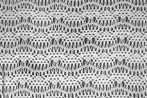 old-fashioned crochet lace zigzag pattern on dark gray background photo