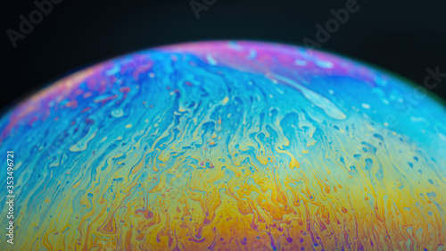 iridescent rainbow on the surface of a soap bubble sphere