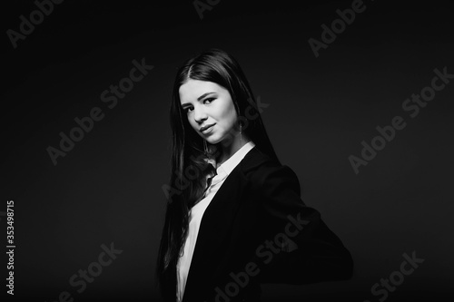 Portrait of a businesswoman in the studio. Beauty and fashion. Girl businessman. Portrait of a girl. Beautiful female face with perfect genuine skin.Beauty.Femininity. Girl in a white shirt and jacket