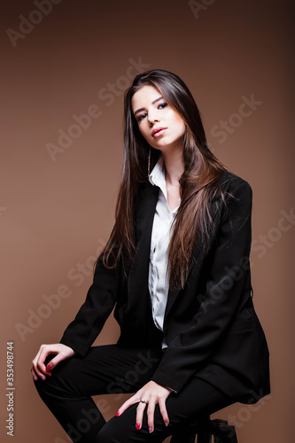 Portrait of a businesswoman in the studio. Beauty and fashion. Girl businessman. Portrait of a girl. Beautiful female face with perfect genuine skin.Beauty.Femininity. Girl in a white shirt and jacket