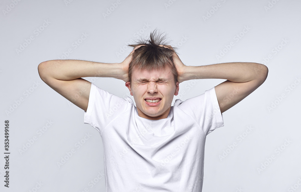 The young guy shows various emotions. Talented portrays the inner state and mood. Advertisement concept The young guy shows various emotions. Talented portrays the inner state and mood. Advertisement concept