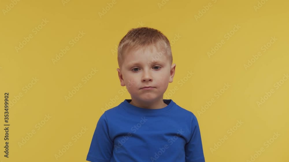 Portrait of happy smiling boy in t-shirt. Attractive and expressive kid in studio. Portrait of happy smiling boy in t-shirt. Attractive and expressive kid in studio.