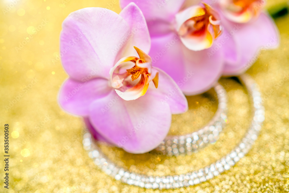 Bracelet and necklace on a gold shiny background