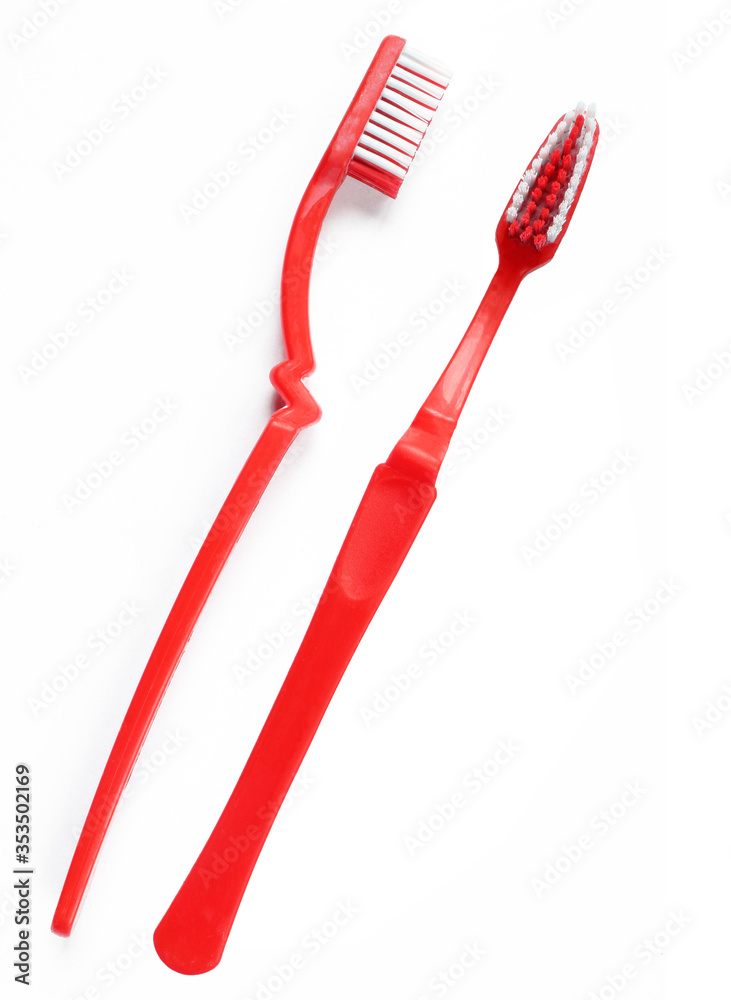 Two sides of red toothbrush isolated on white background. Two sides of red toothbrush isolated on white background.