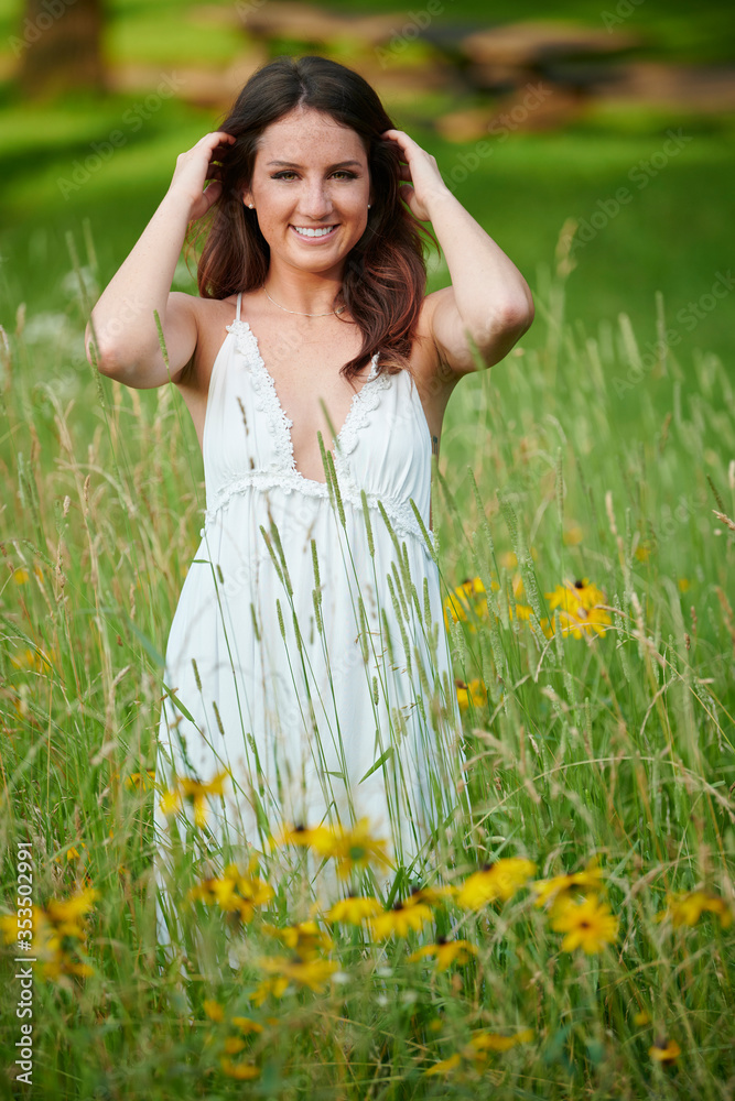 Stunning young Caucasian woman poses in white dressing field - summer fashion Stunning young Caucasian woman poses in white dressing field - summer fashion