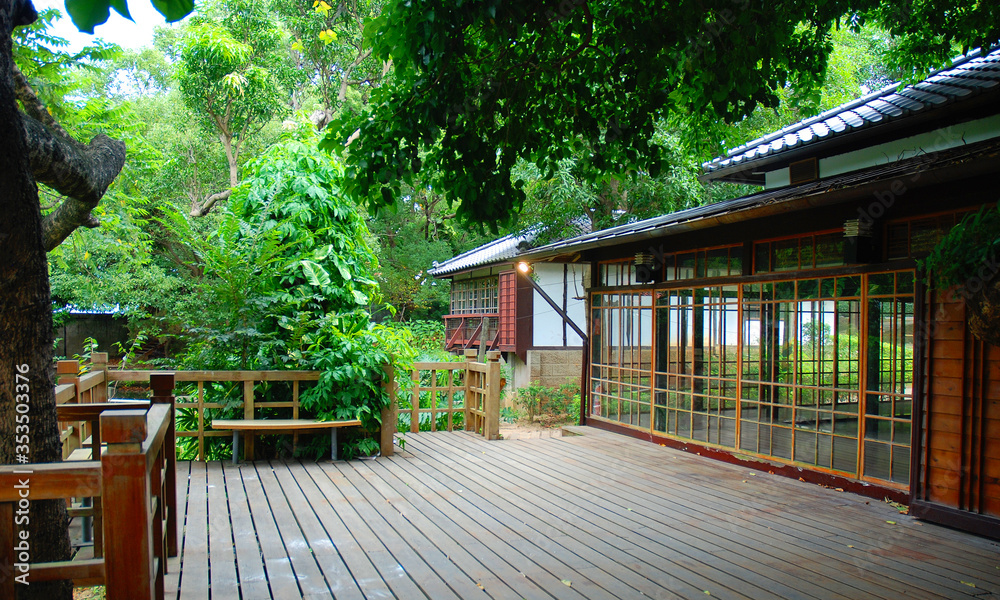 Traditional asian architecture with wooden terrace in green surrounding Traditional asian architecture with wooden terrace in green surrounding