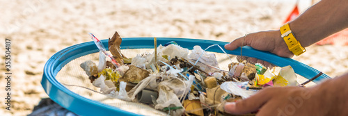 Beach Cleaning. in panoramic view. Cleaning dirty beaches by the action of man. Sustainability of the planet and preservation of nature. Banner web. photo