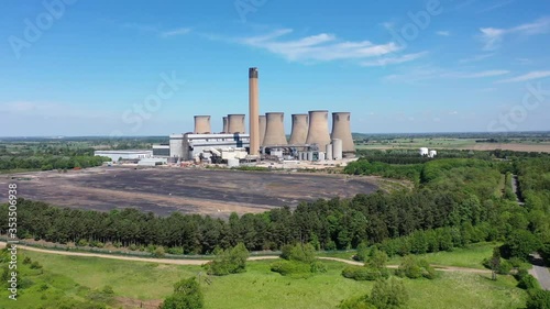 Aerial footage of the Eggborough Power station showing the eight cooling towers and chimneys along side farmers fields on a bright sunny summers day located in Goole, West Riding of West Yorkshire photo