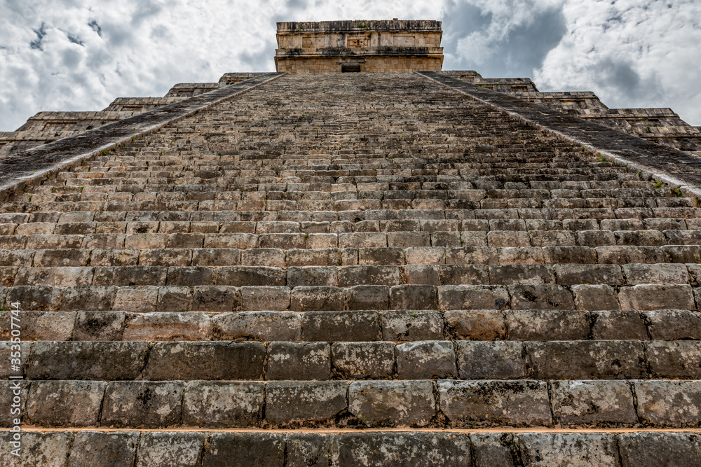 View of the Kukulcan pyramid in the Mayan archeological area of Chichen Itza (Yucatan, Mexico). View of the Kukulcan pyramid in the Mayan archeological area of Chichen Itza (Yucatan, Mexico).