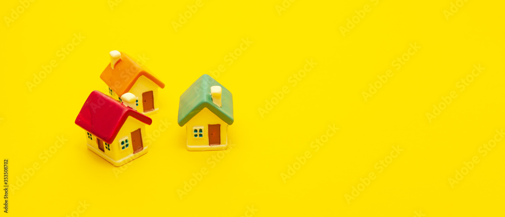 Colored houses on a yellow background, space for text