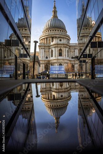 Photography Reflection of St Paul's Cathedral in vertical and horizontal planes against a bright blue sky