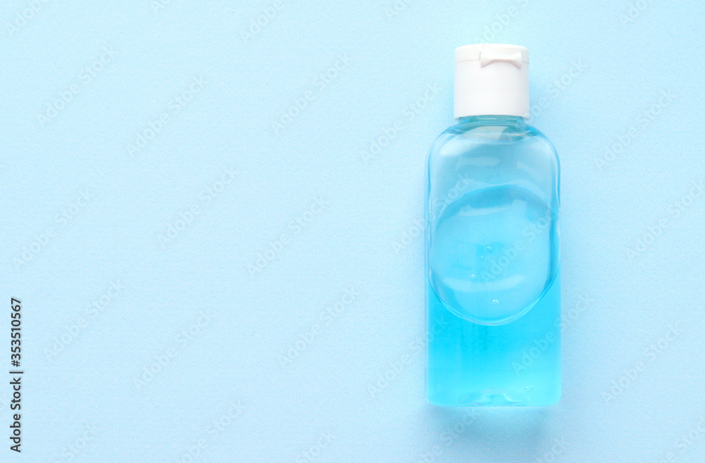 Antibacterial gel for hand and surface disinfection in a transparent plastic bottle on a blue background. Space for text. Selective focus. Copy space. Prevention of coronavirus Antibacterial gel for hand and surface disinfection in a transparent plastic bottle on a blue background. Space for text. Selective focus. Copy space. Prevention of coronavirus