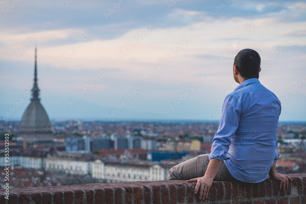 Man tourist enjoy panorama of Turin. Amazing scenic view on Mole Antonelliana. Man explore Piemonte, Italy. Town and mountain. Cityscape, old historic architecture. Travel, adventure, lifestyle Man tourist enjoy panorama of Turin. Amazing scenic view on Mole Antonelliana. Man explore Piemonte, Italy. Town and mountain. Cityscape, old historic architecture. Travel, adventure, lifestyle