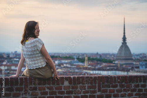 brunette woman enjoy panorama of Turin. Amazing scenic view on Mole Antonelliana. Girl explore Piemonte, Italy. Town and mountain. Cityscape, old historic architecture. Travel, adventure, lifestyle © photomaticstudio