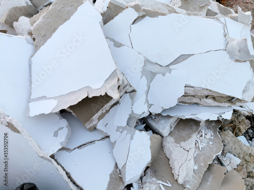 Demolished white brocken plasterboard wall, construction and repair