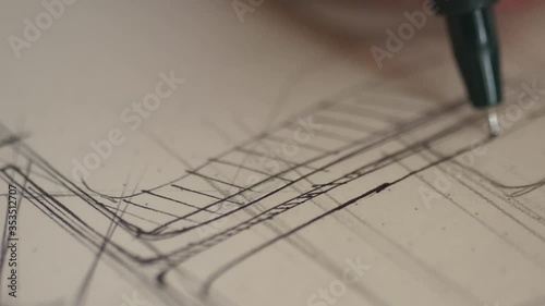 designer draws sketch with fine point pen  photo