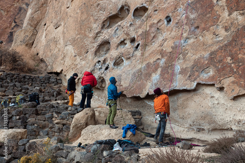 Man belaying a rock climber at Smith Rock State Park in Oregon photo