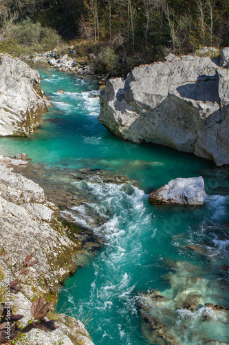 Kobarid, Slovenia - October 28, 2014: The Soca river flows through western Slovenia and its source lies in the Julian Alps. One of the most beautiful rivers in Europa, known for its emerald color.