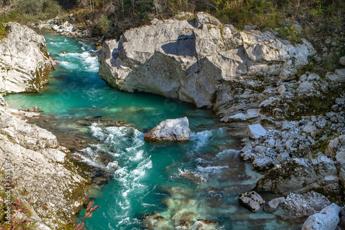 Kobarid, Slovenia - October 28, 2014: The Soca river flows through western Slovenia and its source lies in the Julian Alps. One of the most beautiful rivers in Europa, known for its emerald color.