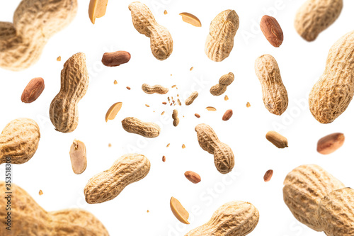 Collection of peanuts falling isolated on white background. Selective focus