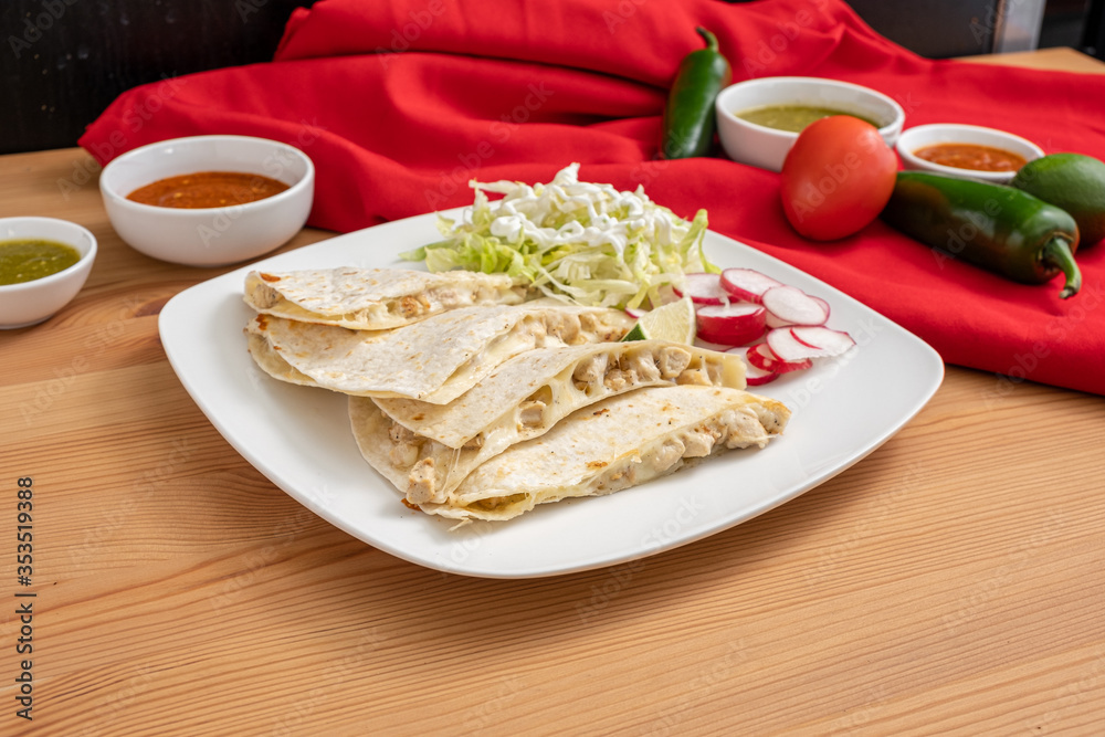 Chicken quesadilla made with Mexican cheese and free-range chicken. A cheap and easy meal from a Mexican restaurant. 