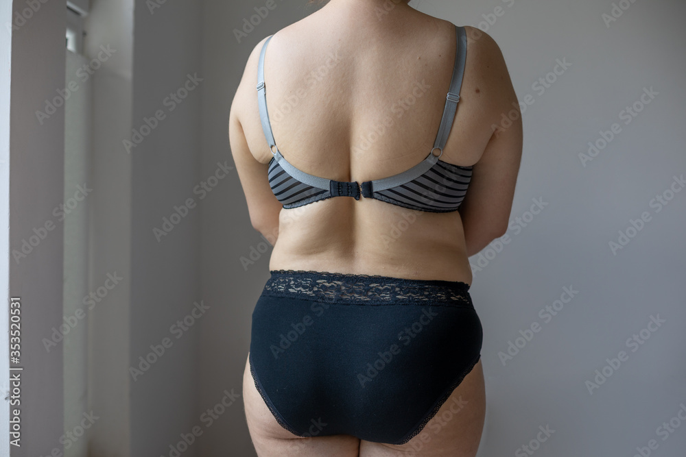 Natural Real Body Plus Size Woman in lingerie showing fat back Stock Photo