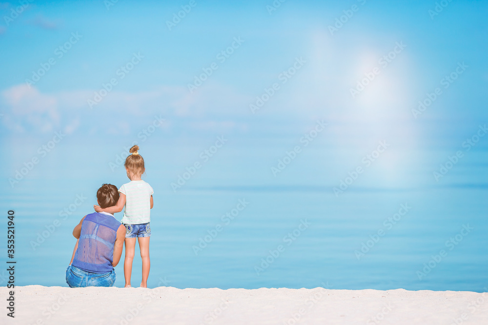 Beautiful mother and daughter on the beach enjoying summer vacation. Beautiful mother and daughter on the beach enjoying summer vacation.