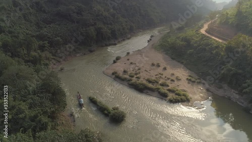 Wallpaper Mural Aerial shot of tourists in boat on river amidst forest, drone panning over trees on mountains - Mekong River, Laos Torontodigital.ca
