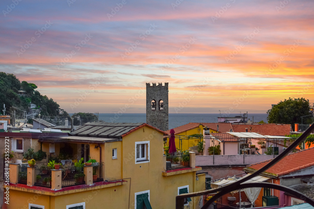 The colorful italian village of Monterosso al Mare, part of the Italian Riviera at Cinque Terre with the sea, town and bell tower in view The colorful italian village of Monterosso al Mare, part of the Italian Riviera at Cinque Terre with the sea, town and bell tower in view