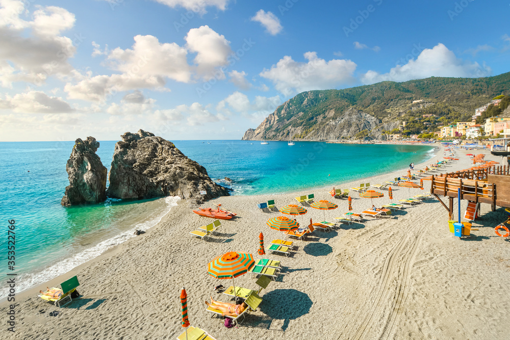 Chairs and umbrellas fill the Spiaggia di Fegina, the wide sandy beach in front of the old section of the village of Monterosso al Mare, Italy