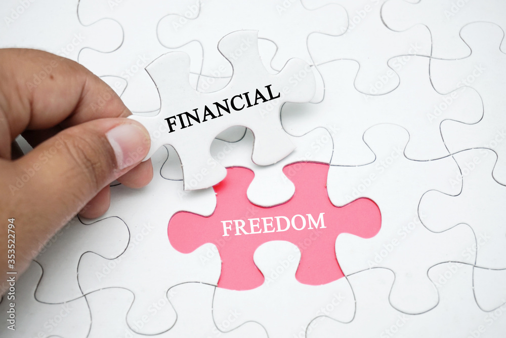 Missing puzzle with a word FINANCIAL FREEDOM. Business concept puzzle piece. Business and finance concept. Missing puzzle with a word FINANCIAL FREEDOM. Business concept puzzle piece. Business and finance concept.