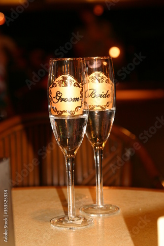 Wedding Goblets, bride and groom in gold Champaign flutes wedding night time.