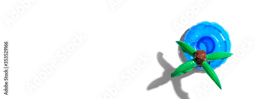 Summer concept with a palm tree float overhead view - flat lay