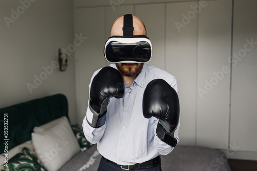 Augmented 3D world. Cyber sportsman boxing gloves. Man play game in VR glasses. Cyber sport concept. Man boxer virtual reality headset simulation. Cyber coach online training. Explore cyber space