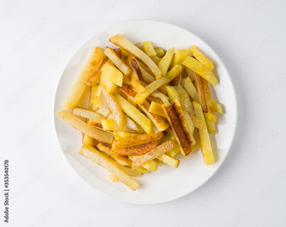 Appetizing fried potatoes on a white plate. Top view