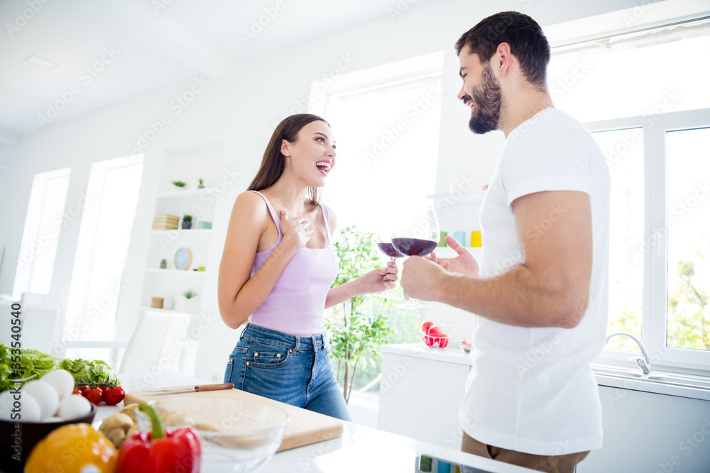 Photo of positive two people stay home quarantine have date man woman hold glass wine say tell comic humor news enjoy laugh in house kitchen indoors Photo of positive two people stay home quarantine have date man woman hold glass wine say tell comic humor news enjoy laugh in house kitchen indoors