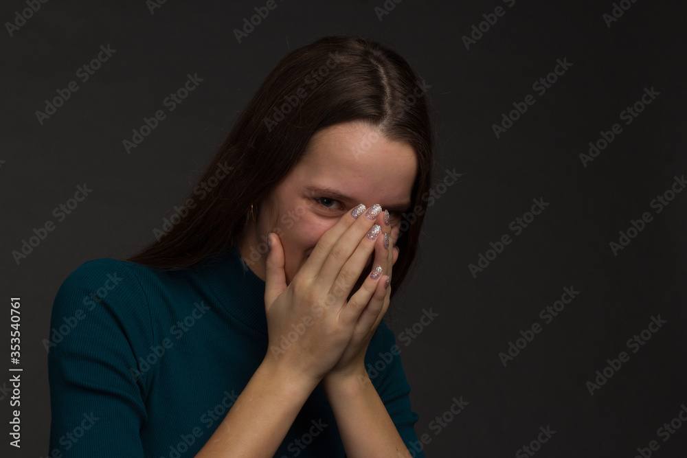 Studio portrait of a young girl with long hair on black background Studio portrait of a young girl with long hair on black background