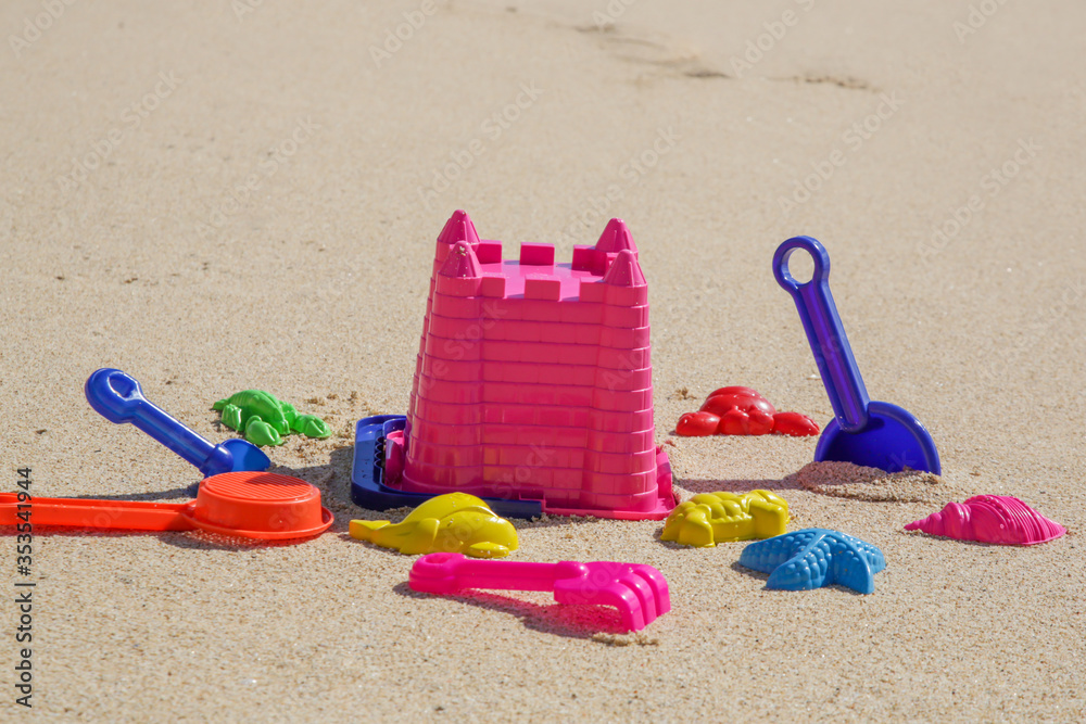 Plastic children toys on the sand beach. Plastic children toys on the sand beach.