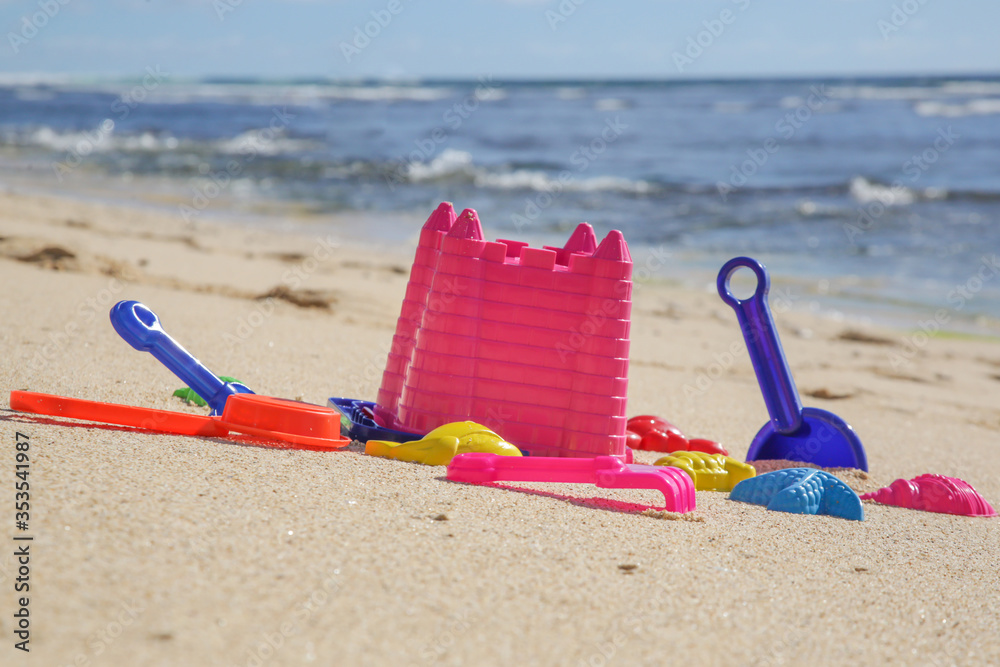 Plastic children toys on the sand beach. Plastic children toys on the sand beach.
