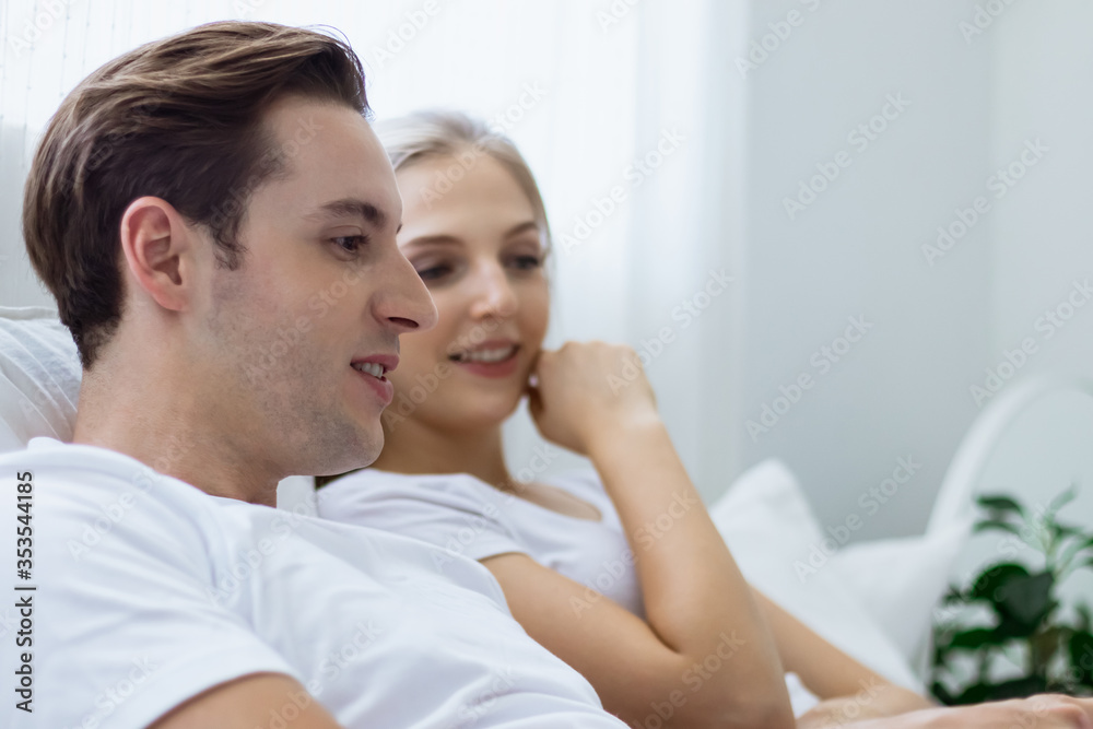 Happy & smiling attractive young cute caucasian couple in love enjoying activity toghether in bedroom at home. Happiness family of beautiful romantic married lover or marriage relationship Happy & smiling attractive young cute caucasian couple in love enjoying activity toghether in bedroom at home. Happiness family of beautiful romantic married lover or marriage relationship