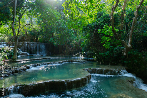 Fototapeta Naklejka Na Ścianę i Meble -  This is the beauty of the Kuangsi Waterfalls. So many different levels, such colourful pools, all surrounded by lush green jungle in Luang Prabang, Laos.
