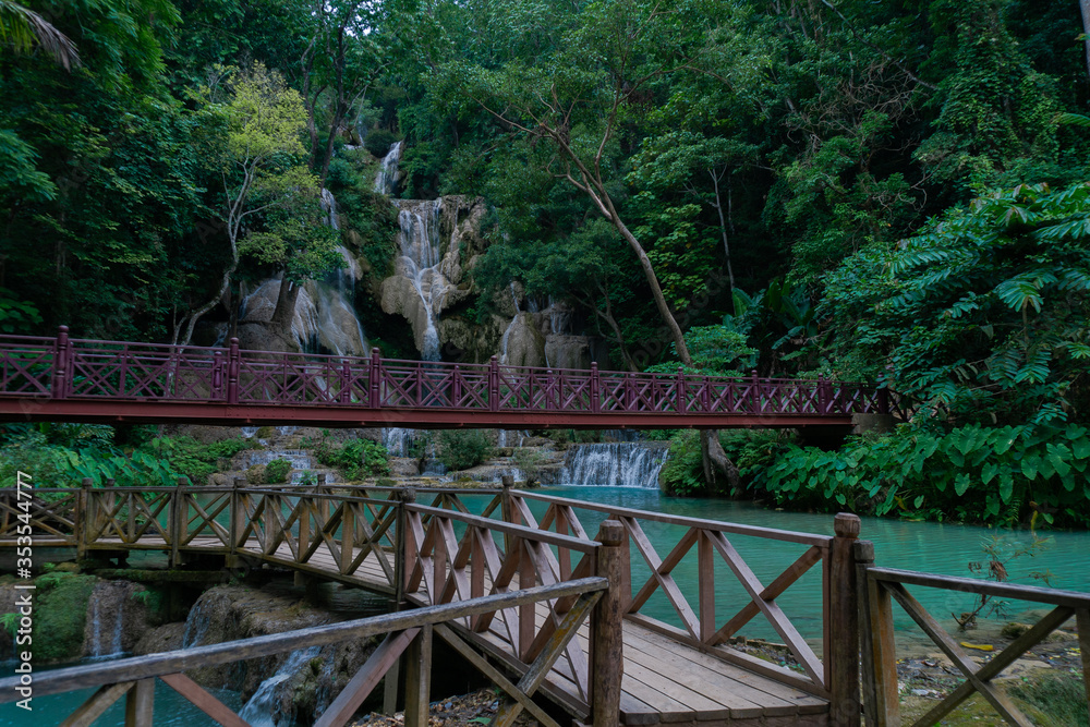 Kuangsi waterfall has two distinct sections. From high on the mountain ridge, the water falls down seven steep rock cliffs into the pool under this bridge in Luang Prabang, Laos. Kuangsi waterfall has two distinct sections. From high on the mountain ridge, the water falls down seven steep rock cliffs into the pool under this bridge in Luang Prabang, Laos.