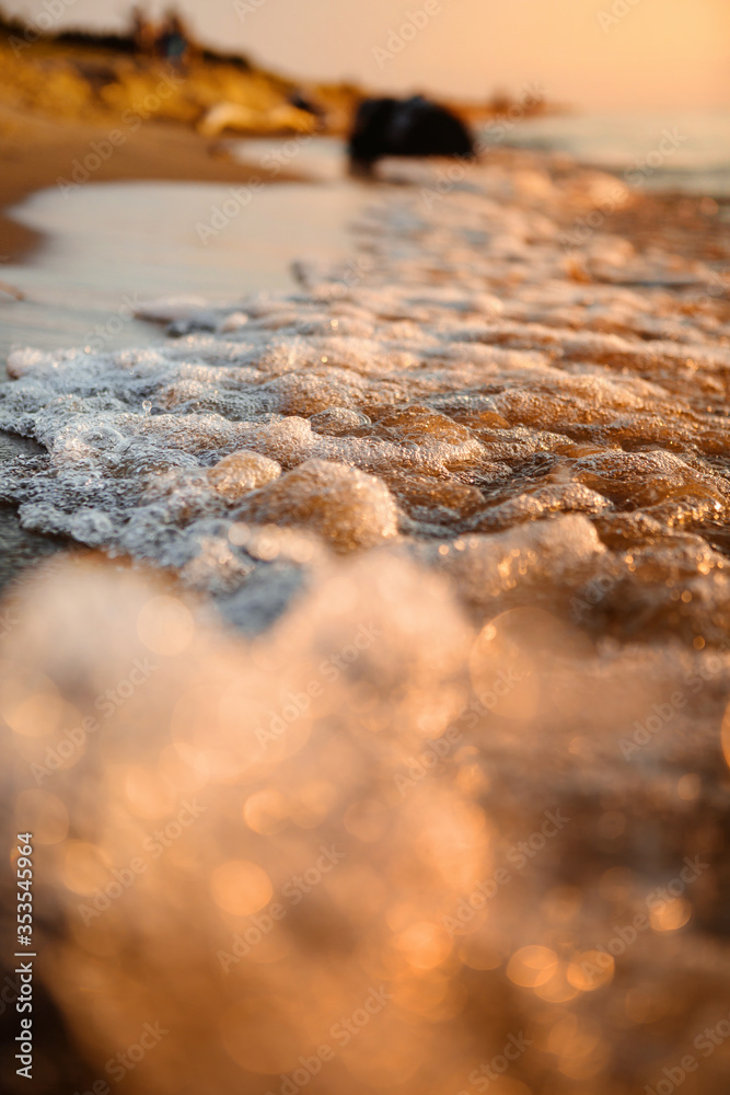 Close up Bokeh of the Waves Water being lit up by the Warm Orange Glow of the Sun during Sunset Close up Bokeh of the Waves Water being lit up by the Warm Orange Glow of the Sun during Sunset