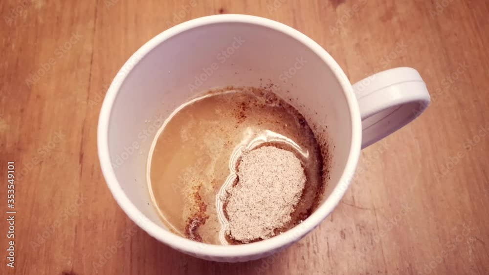 Coffee powder mixed with hot water in a white cup for drinks in the morning. Selective focus footage. Coffee powder mixed with hot water in a white cup for drinks in the morning. Selective focus footage.
