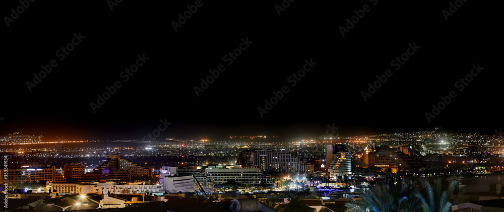 Panorama of the city of Eilat at night. A popular resort city on the Red Sea, with beaches and hotels. On the other side of