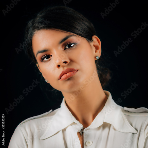 Emotion Jealousy. Portrait of a beautiful jealous young woman, studio portrait, black background