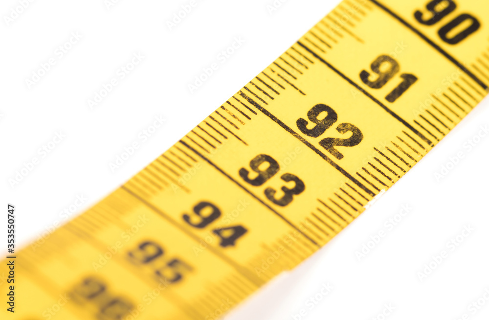 Close-up of a yellow measuring tape isolated on white - 92 Close-up of a yellow measuring tape isolated on white - 92