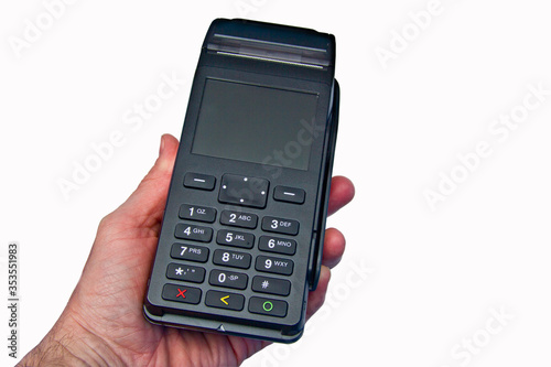 Hand is holding a redit card payment terminal on blank background.