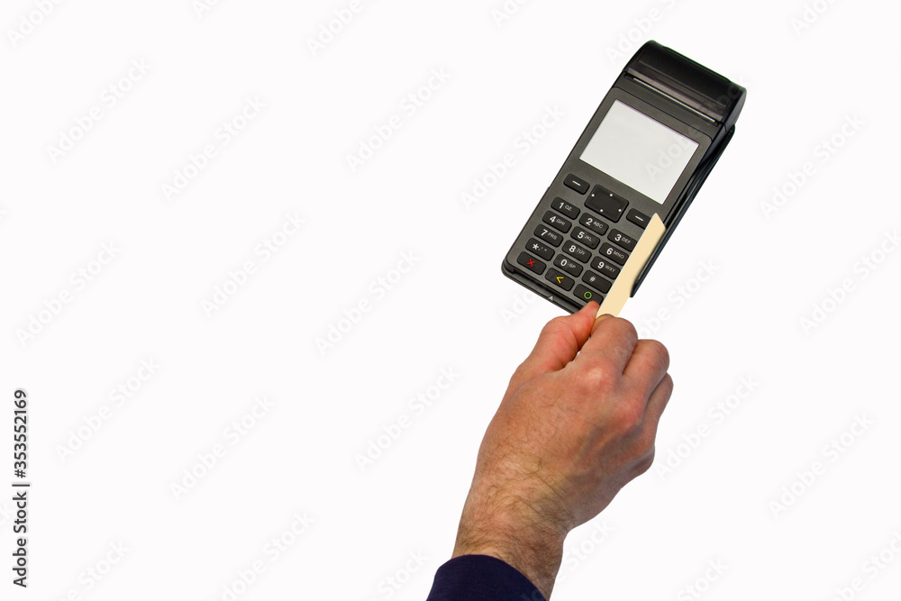The hand holds a credit card on the payment terminal. Isolated on white background The hand holds a credit card on the payment terminal. Isolated on white background